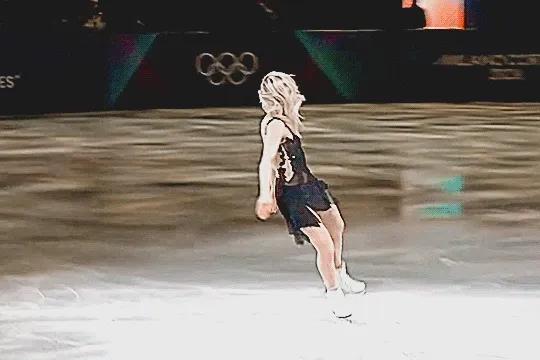 amber glenn doing a double axel jump at the olympic figure skating gala